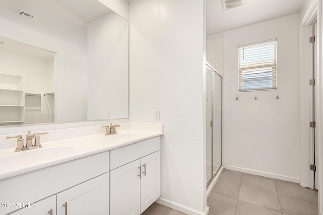 full bathroom featuring a shower stall, visible vents, a sink, and tile patterned floors