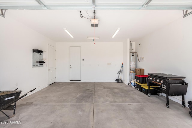 garage featuring water heater and a garage door opener