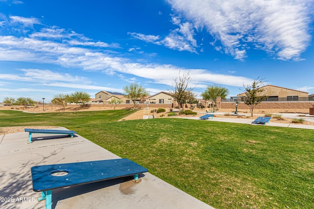 view of property's community with a residential view and a yard