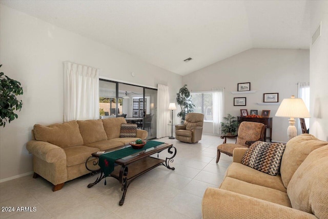 tiled living room featuring vaulted ceiling and plenty of natural light