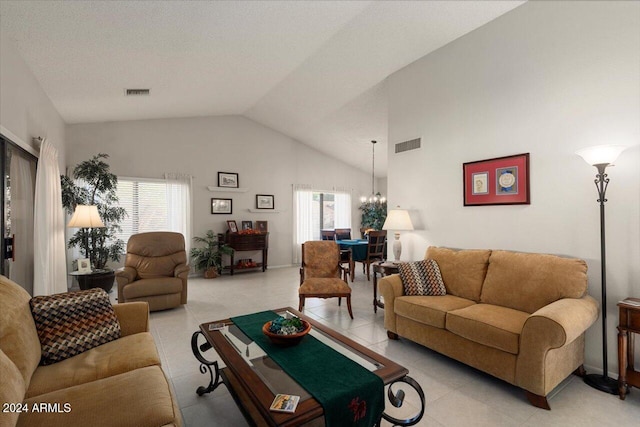 living room with high vaulted ceiling and a chandelier