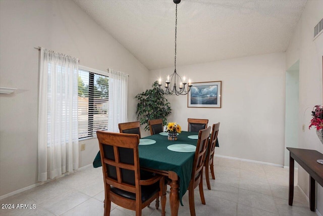 dining room with light tile patterned floors, a textured ceiling, an inviting chandelier, and vaulted ceiling