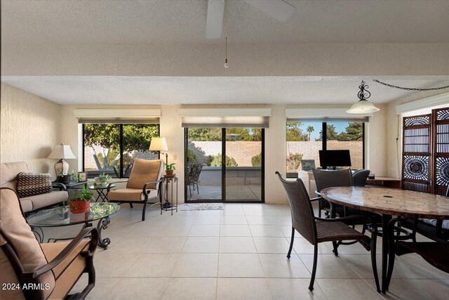 tiled dining space with a textured ceiling