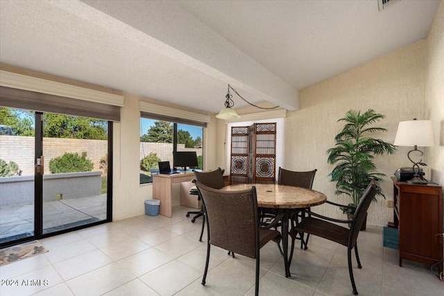 tiled dining area with vaulted ceiling with beams and a textured ceiling