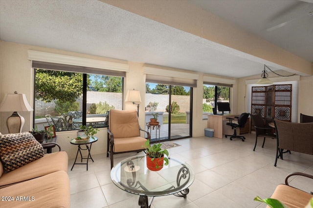 living room with a textured ceiling and light tile patterned flooring