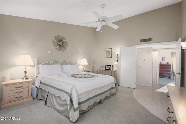 bedroom featuring ceiling fan and a high ceiling