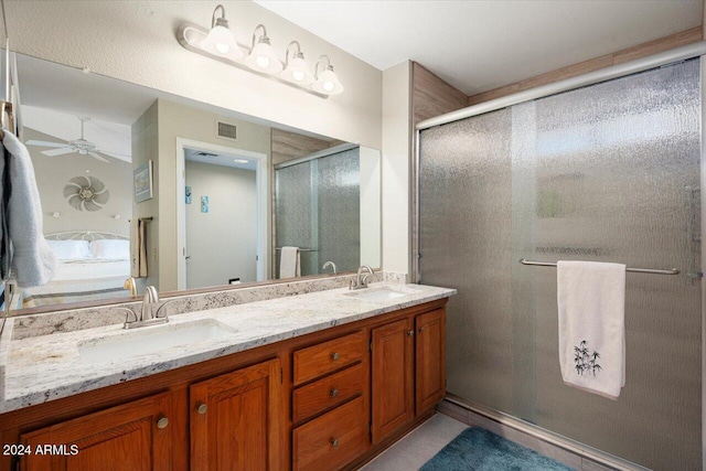 bathroom with vanity, a shower with door, and ceiling fan