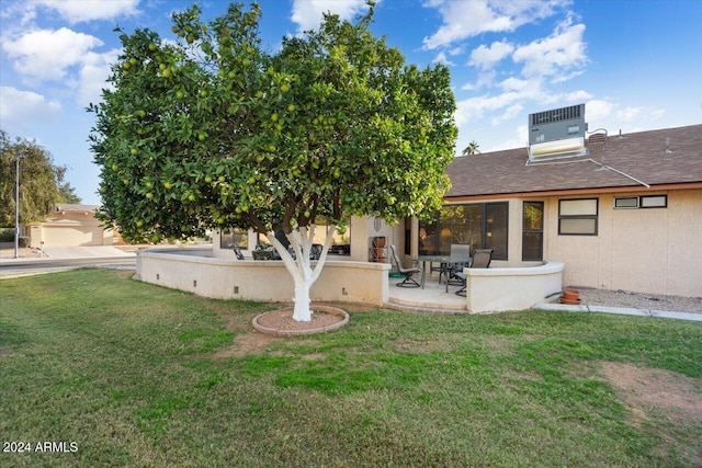 back of property featuring a yard and cooling unit