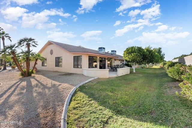 rear view of house with a yard