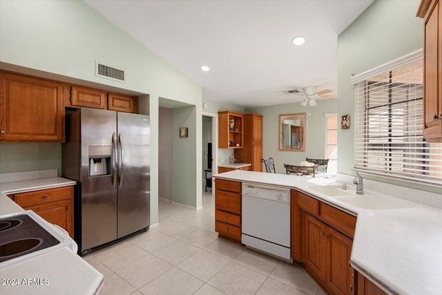 kitchen featuring white appliances, ceiling fan, sink, light tile patterned floors, and lofted ceiling