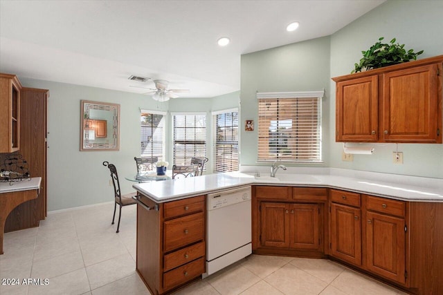 kitchen featuring ceiling fan, sink, kitchen peninsula, white dishwasher, and light tile patterned floors