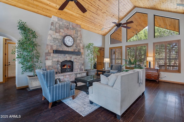 living room featuring a fireplace, ceiling fan, wooden ceiling, and high vaulted ceiling