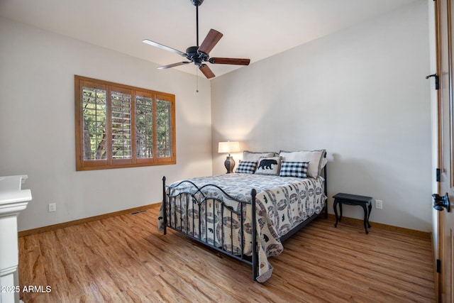 bedroom with wood finished floors and baseboards