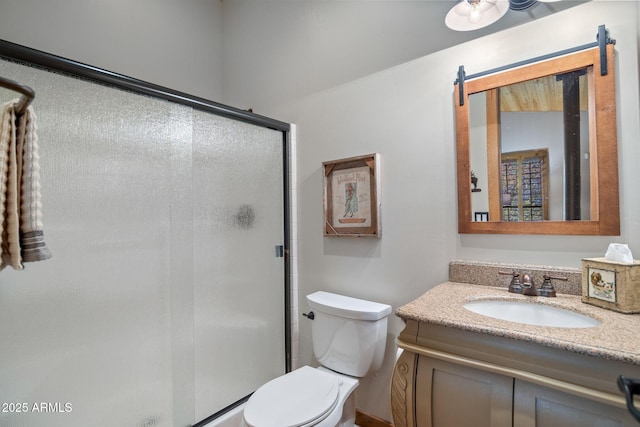 bathroom with vanity, toilet, and a stall shower