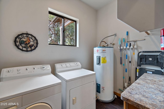 laundry area featuring water heater, dark wood finished floors, laundry area, and washer and dryer