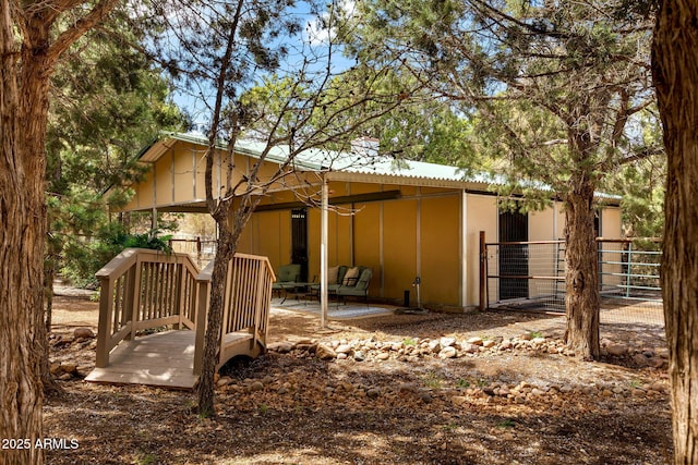 rear view of house featuring board and batten siding and a patio