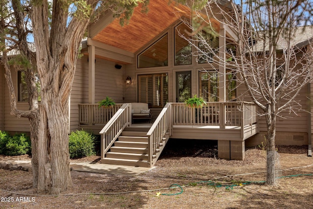 view of exterior entry with a wooden deck