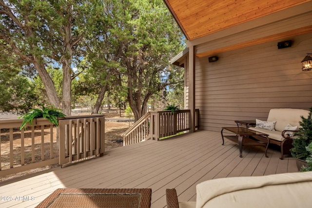 wooden terrace with an outdoor living space