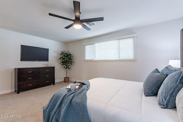 bedroom with ceiling fan and light colored carpet