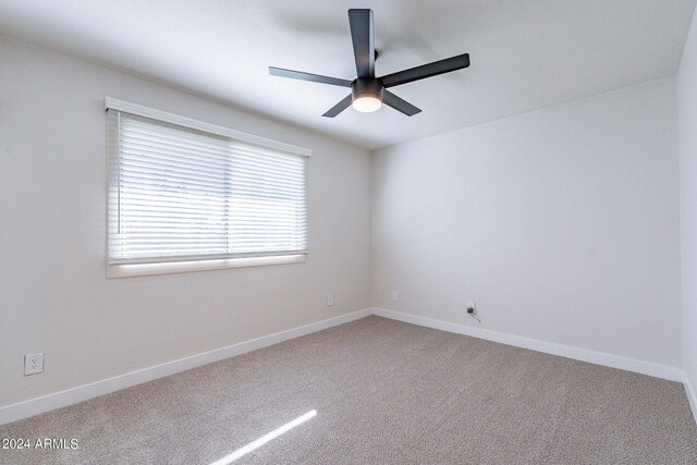 empty room featuring carpet floors and ceiling fan