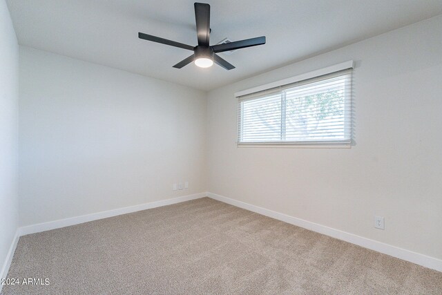 carpeted empty room with ceiling fan