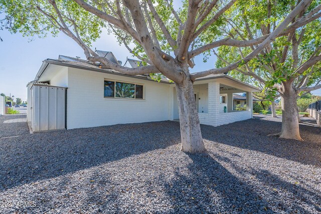 view of property exterior featuring a shed