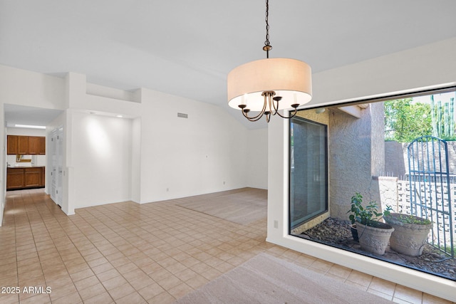 9797 N 100th Pl, Scottsdale, AZ 85258 - spare room with tile patterned flooring, a chandelier, and lofted ceiling