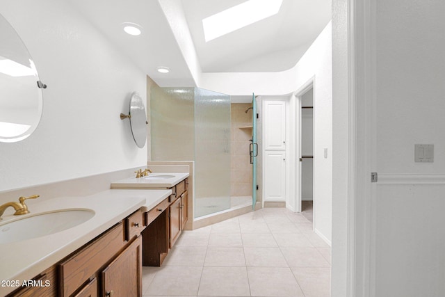 9797 N 100th Pl, Scottsdale, AZ 85258 - full bath with a stall shower, double vanity, tile patterned floors, recessed lighting, and a skylight
