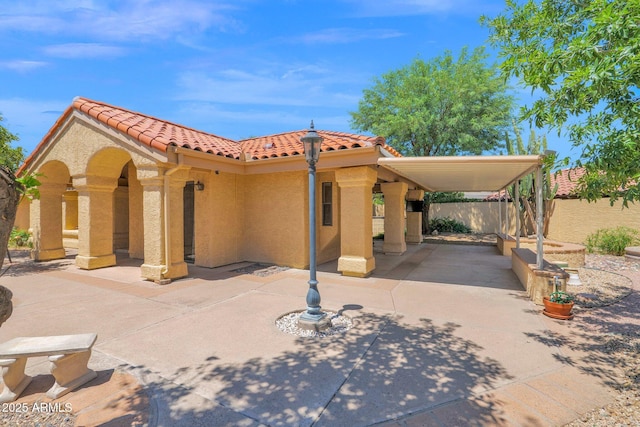 9797 N 100th Pl, Scottsdale, AZ 85258 - mediterranean / spanish home featuring a tile roof, a patio, and stucco siding