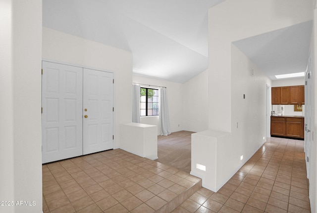 9797 N 100th Pl, Scottsdale, AZ 85258 - foyer with light tile patterned floors, vaulted ceiling, and light carpet