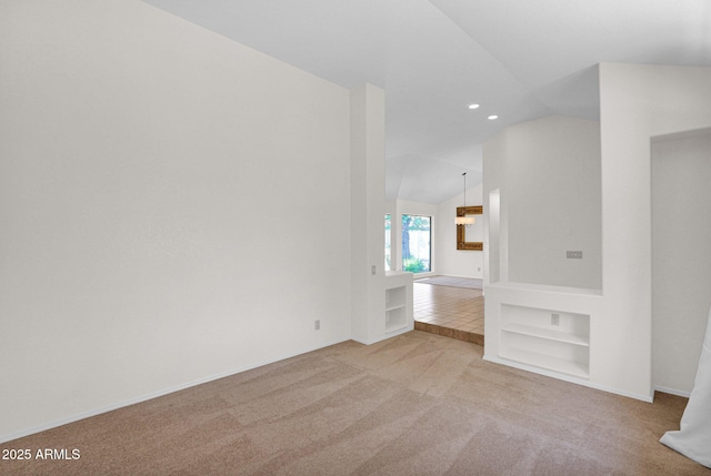 9797 N 100th Pl, Scottsdale, AZ 85258 - unfurnished room featuring built in features, vaulted ceiling, carpet, and recessed lighting