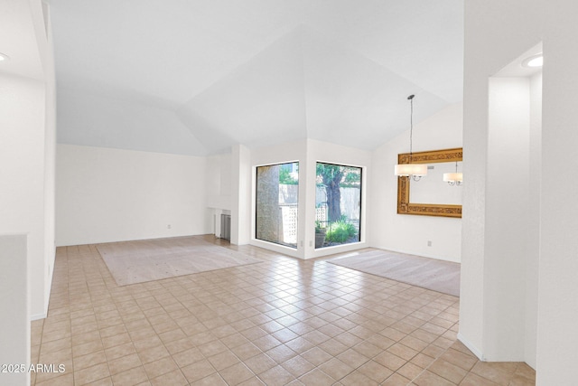 9797 N 100th Pl, Scottsdale, AZ 85258 - unfurnished living room with radiator heating unit, vaulted ceiling, and light tile patterned floors