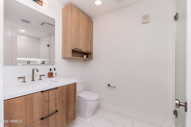 bathroom with tile patterned floors, vanity, and toilet