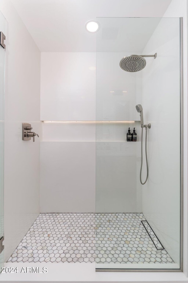 bathroom with a tile shower