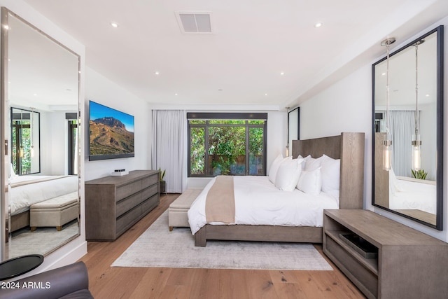 bedroom with light hardwood / wood-style floors