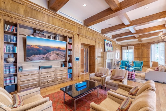 living room with beam ceiling, coffered ceiling, built in features, wood walls, and light wood-type flooring