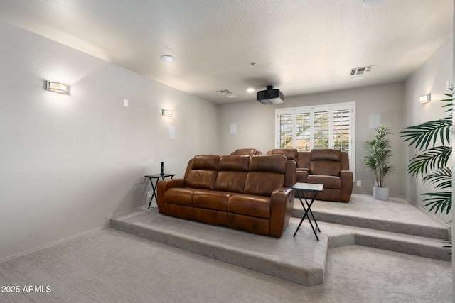 carpeted home theater with a textured ceiling