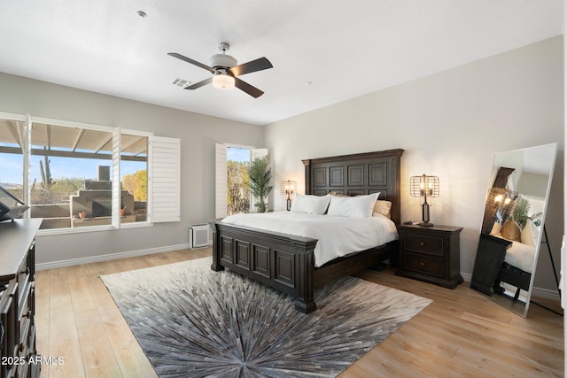 bedroom with light hardwood / wood-style flooring and ceiling fan