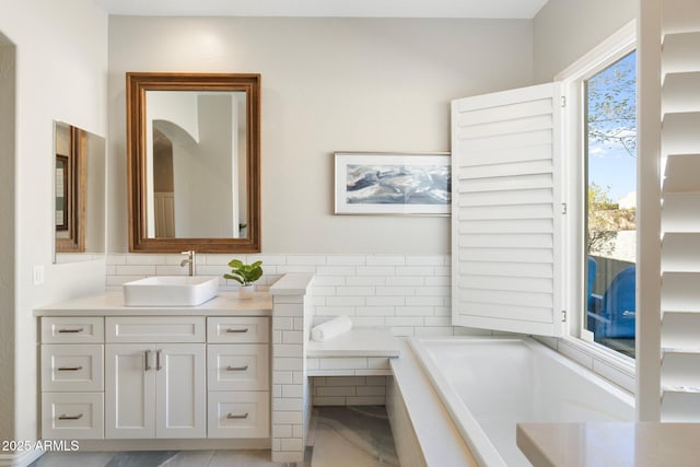 bathroom with vanity and a bath