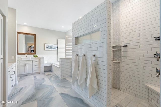 bathroom with vanity, plus walk in shower, and tile walls