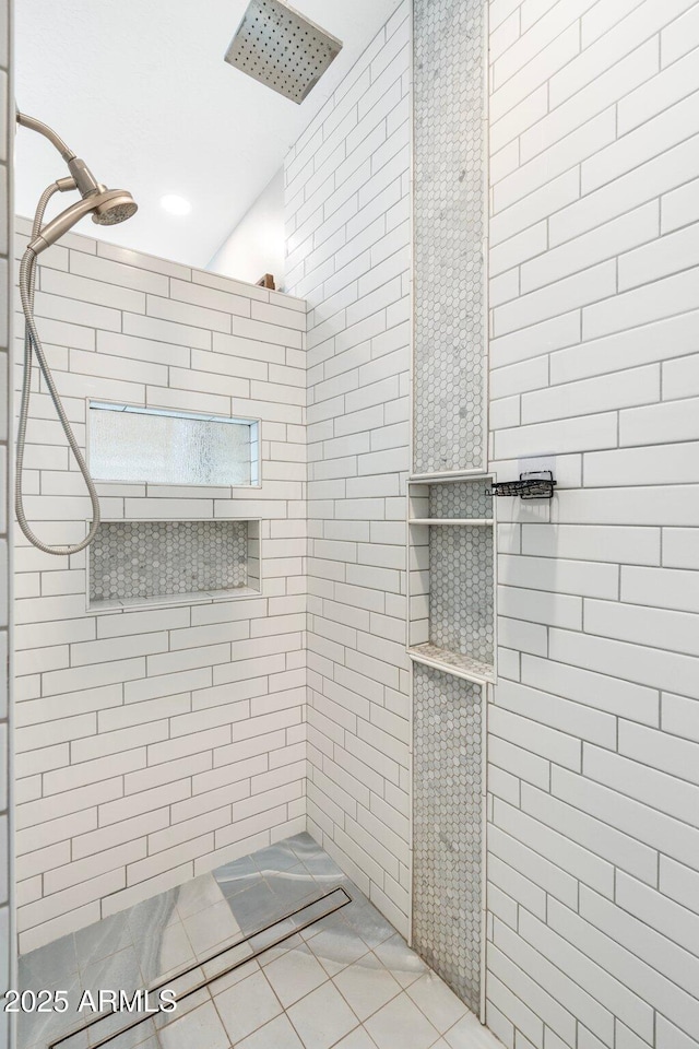 bathroom with tiled shower