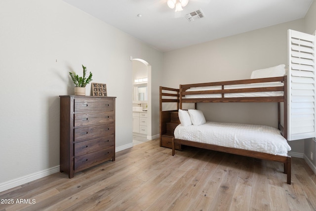 bedroom featuring light wood-type flooring and ensuite bath