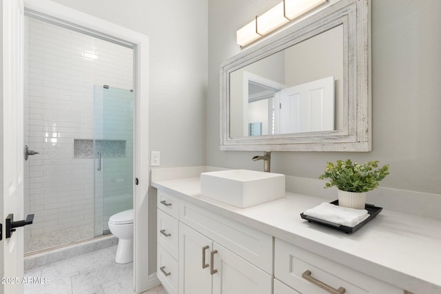 bathroom with vanity, walk in shower, and toilet