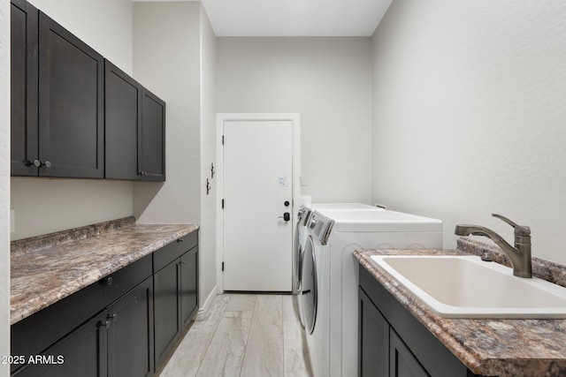 laundry room featuring sink, cabinets, and independent washer and dryer