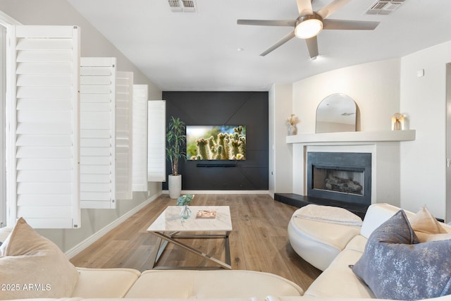 living room with wood-type flooring and ceiling fan