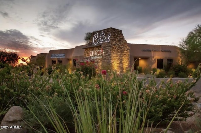 view of outdoor building at dusk