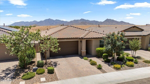 11951 W Wier Ave, Avondale, AZ 85323 - view of front of property featuring a tiled roof, an attached garage, stucco siding, and decorative driveway