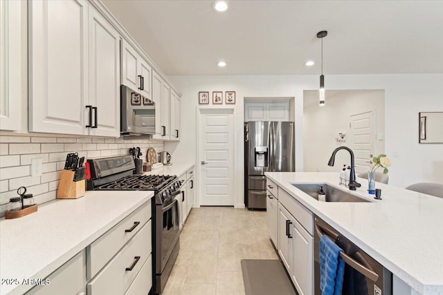 11951 W Wier Ave, Avondale, AZ 85323 - kitchen with stainless steel appliances, tasteful backsplash, an island with sink, recessed lighting, and decorative light fixtures
