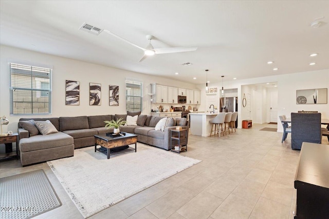 11951 W Wier Ave, Avondale, AZ 85323 - living area with plenty of natural light, a ceiling fan, recessed lighting, and light tile patterned flooring