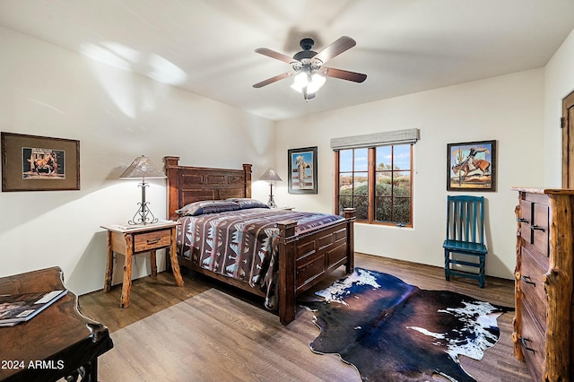 bedroom with ceiling fan and hardwood / wood-style flooring